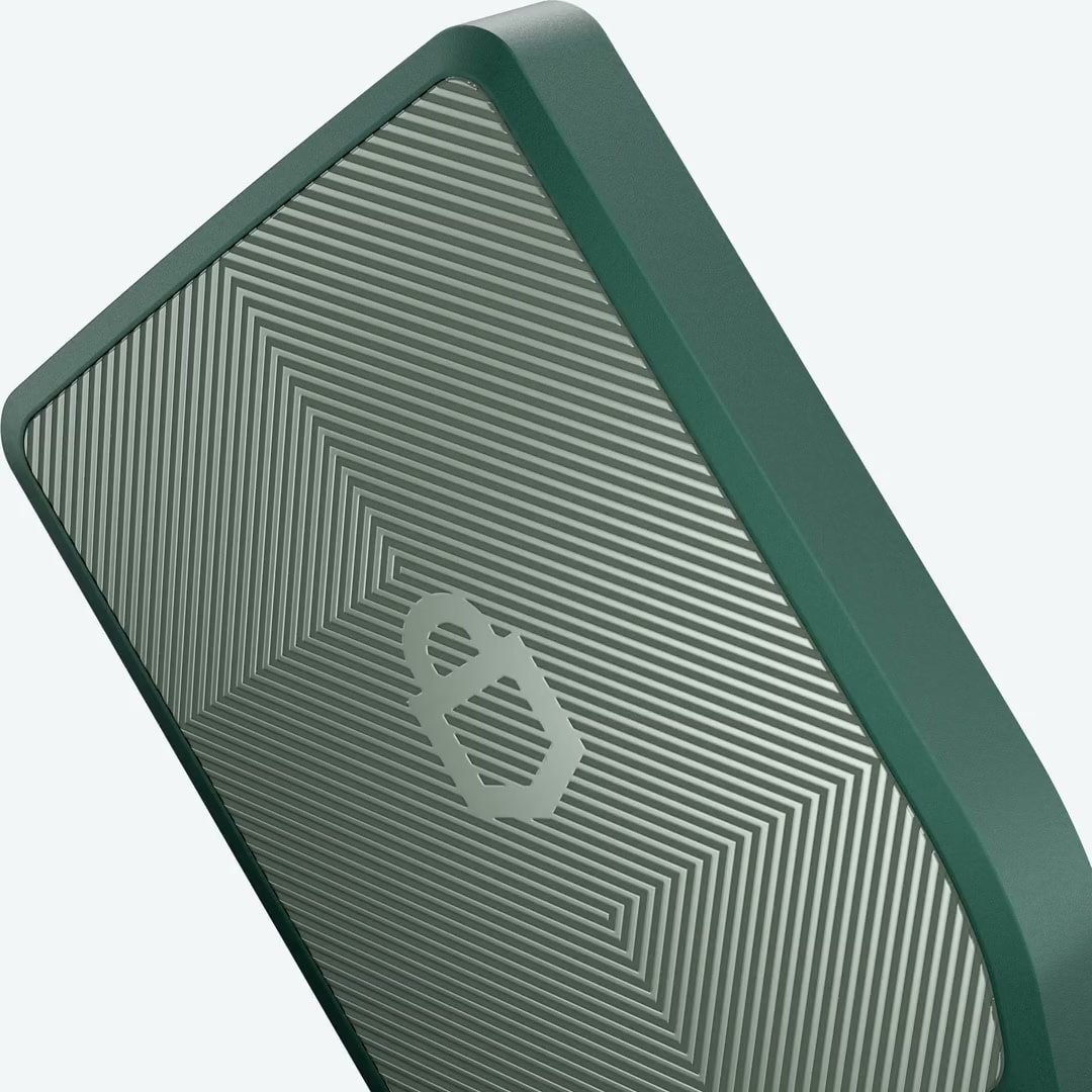 Green Trezor hardware wallet rotating to reveal its screen and textured back