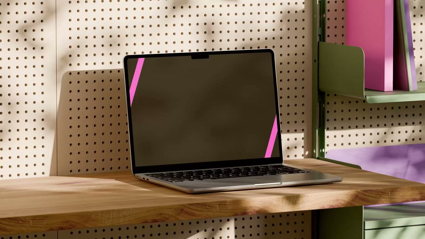 Shelby website on a MacBook in a sunlit workspace with wood surfaces and a perforated wall