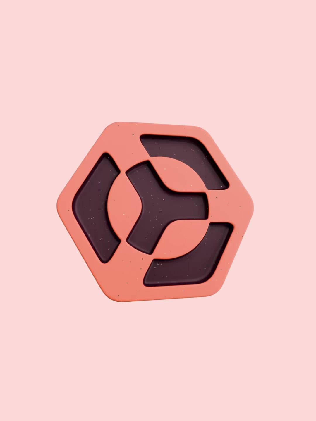 Rotating coral Shelby pin showing the geometric mark and metal clasp